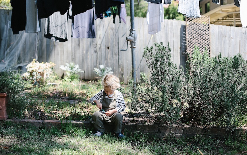 small child under a washing line